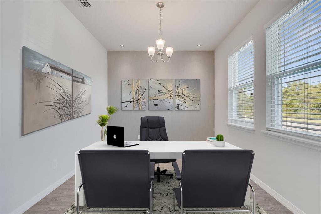 A two-story house with a beige exterior, a paved driveway, and a basketball hoop — 8048 SCAGEL STREET, ORLANDO, FL