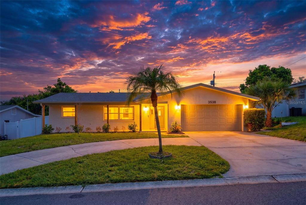 A single-story house with a brick facade, a two-car garage, and a palm tree — 3538 SHADY BLUFF DRIVE, LARGO, FL