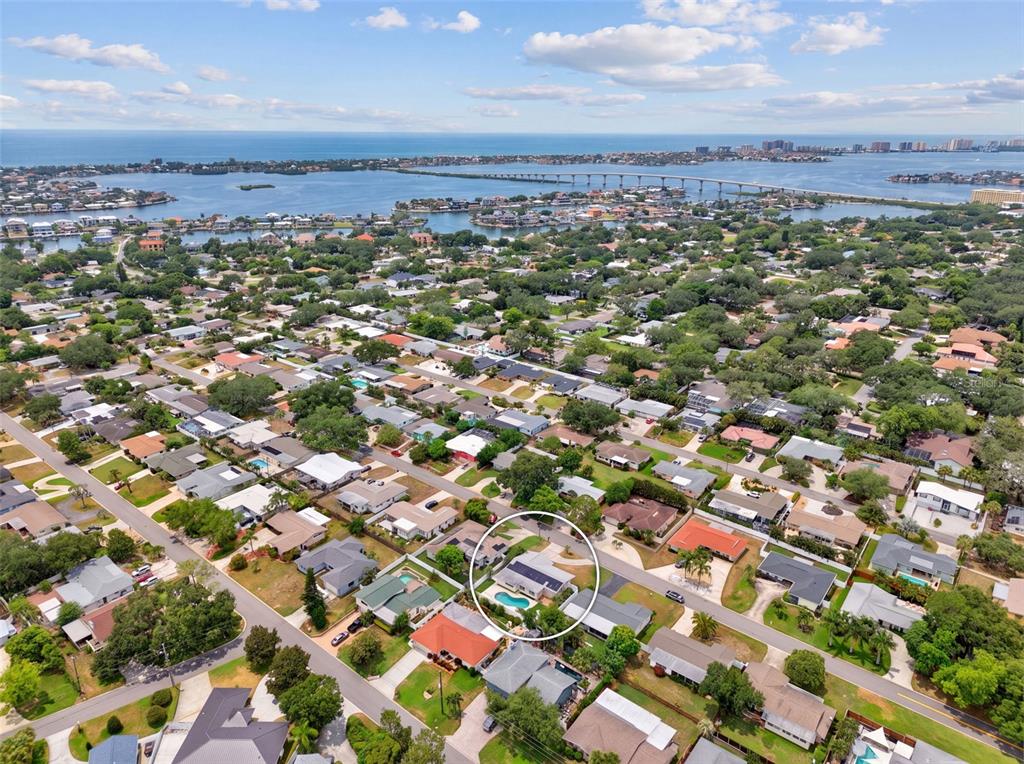An aerial view shows a residential neighborhood with a circled house featuring a swimming pool — 3538 SHADY BLUFF DRIVE, LARGO, FL