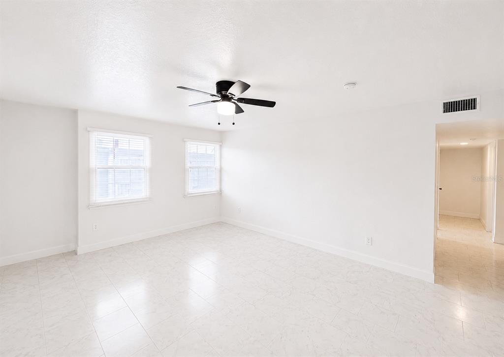An empty room with white walls, tile flooring, and a ceiling fan — 2751 L B MCLEOD ROAD UNIT 2751, ORLANDO, FL
