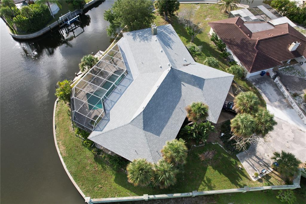 An aerial view of a house with a screened-in pool located on a canal — 6937 MIDNIGHT PASS ROAD, SARASOTA, FL