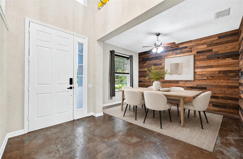 A living room features stained concrete floors, a brown sectional sofa, and wall-mounted floating shelves — 1135 TOLUKE POINT, ORLANDO, FL