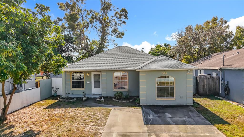 A single-story house with a gray exterior, a concrete driveway, and a front yard — 1926 29TH AVENUE N, ST PETERSBURG, FL