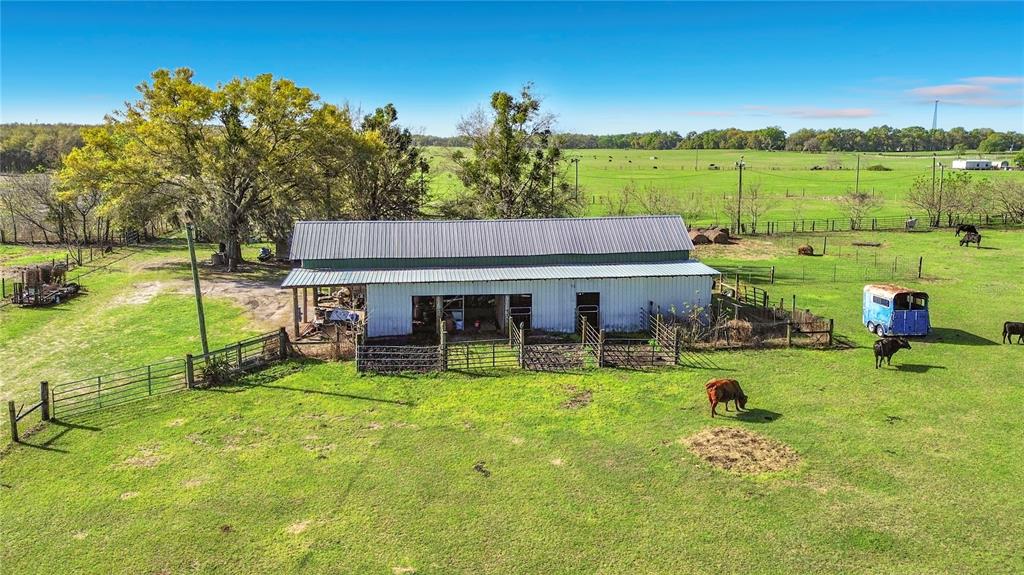 An aerial view shows a large, fenced rural property with a house, barn, and pasture — 855 NE 107TH ROAD, OXFORD, FL