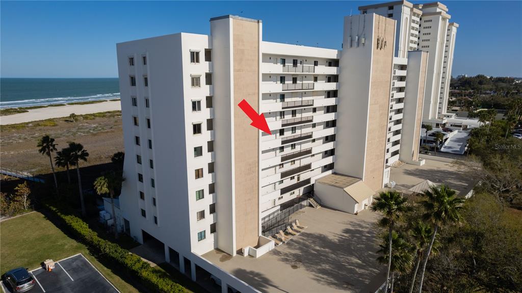 An elevated view of a sandy beach, dunes, and ocean under a clear blue sky — 1250 GULF BOULEVARD UNIT 703, CLEARWATER BEACH, FL