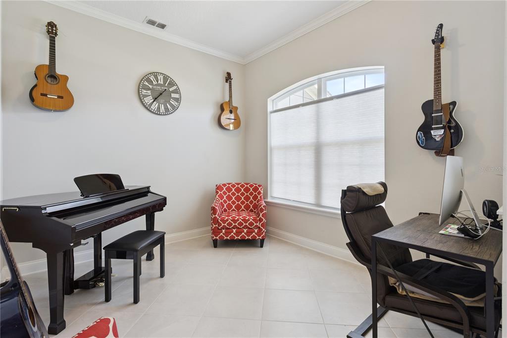 A living room with a high ceiling, staircase, and tile flooring — 16416 GOOD HEARTH BOULEVARD, CLERMONT, FL