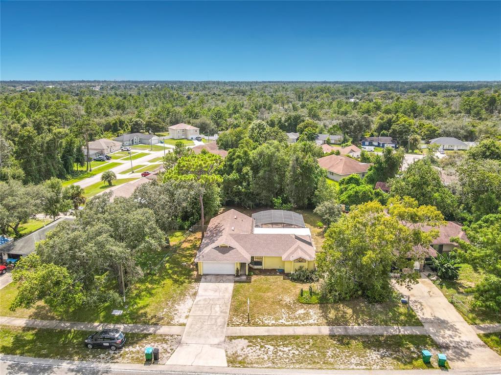 An aerial view of a backyard swimming pool enclosed by a screened-in lanai — 3208 LAKE HELEN OSTEEN ROAD, DELTONA, FL