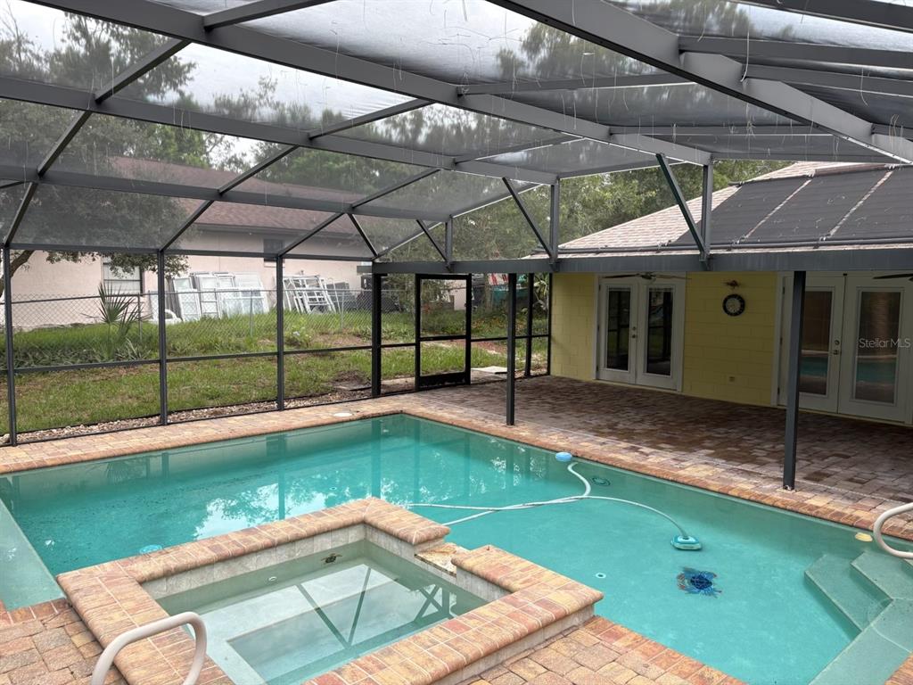 An aerial view of a backyard swimming pool enclosed by a screened-in lanai — 3208 LAKE HELEN OSTEEN ROAD, DELTONA, FL