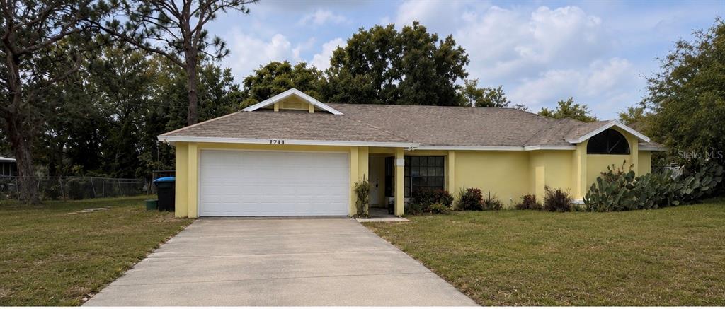 A screened-in pool and spa area with brick pavers and a view of the backyard — 3208 LAKE HELEN OSTEEN ROAD, DELTONA, FL