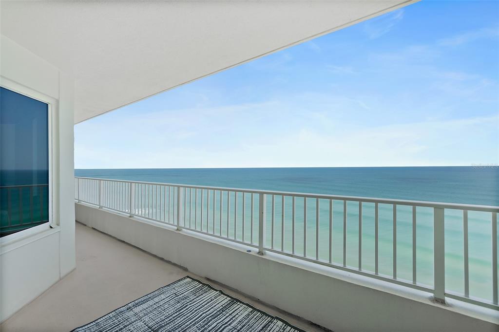 A balcony with a white railing overlooks the ocean under a clear blue sky — 2937 S ATLANTIC AVENUE UNIT 1905, DAYTONA BEACH SHORES, FL