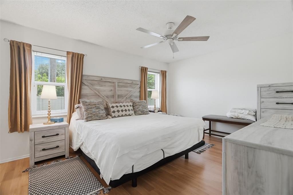 A covered parking area features two numbered spaces with a white SUV and silver sedan — 3828 SAILMAKER LANE, HOLIDAY, FL