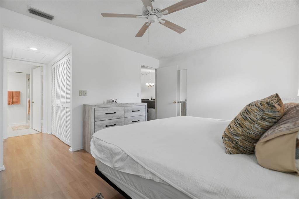 A kitchen features white cabinets, stainless steel appliances, granite countertops, and a small dining table — 3828 SAILMAKER LANE, HOLIDAY, FL
