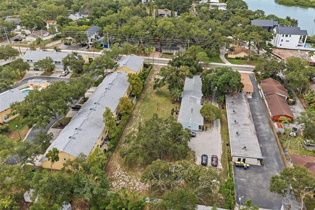 An aerial view shows a multi-family residential property with several buildings and parking areas — SUNSET POINT ROAD, CLEARWATER, FL
