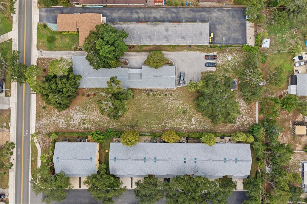 Aerial view of two apartment buildings separated by a large grassy lot and parking area — SUNSET POINT ROAD, CLEARWATER, FL