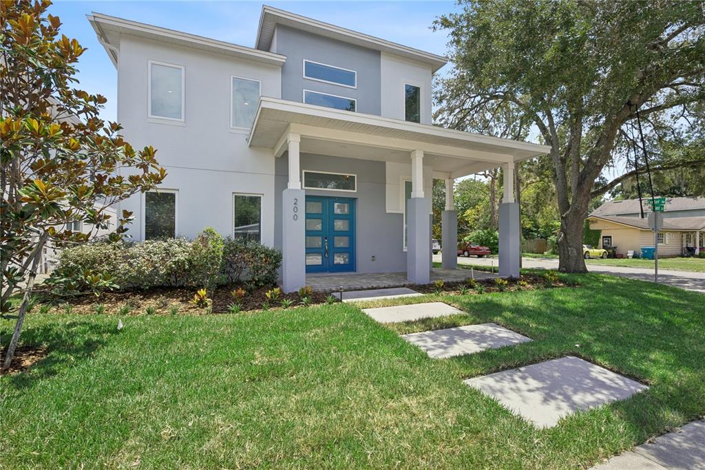 A modern two-story house features a blue front door, gray accents, and a covered porch — 200 E GRANT STREET, ORLANDO, FL