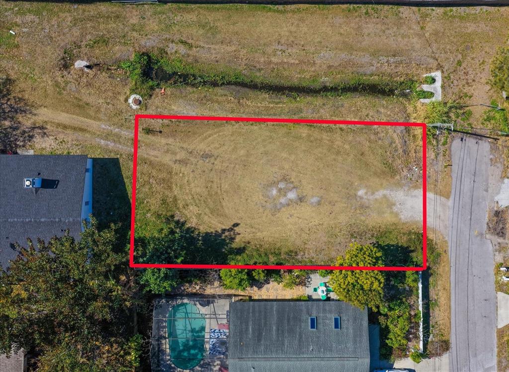 An aerial view shows a rectangular vacant lot outlined in red next to residential houses — BRAGINTON STREET, LARGO, FL