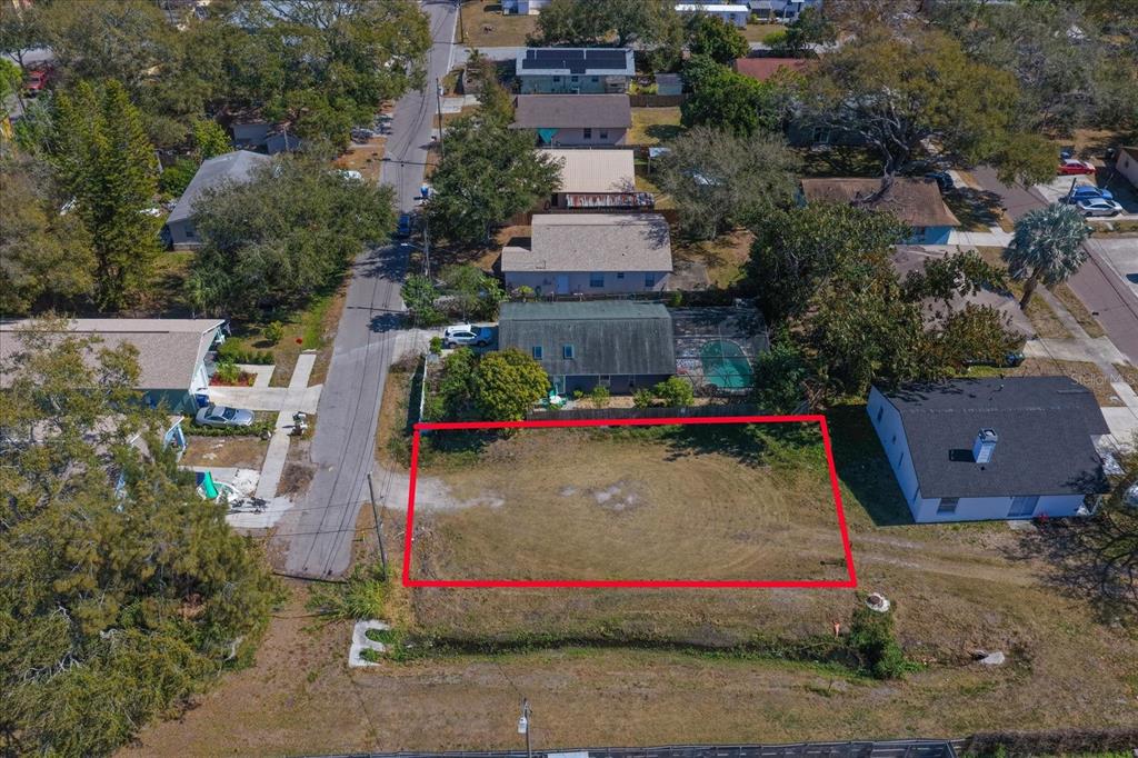 An aerial view shows a vacant, rectangular residential lot outlined in red — BRAGINTON STREET, LARGO, FL