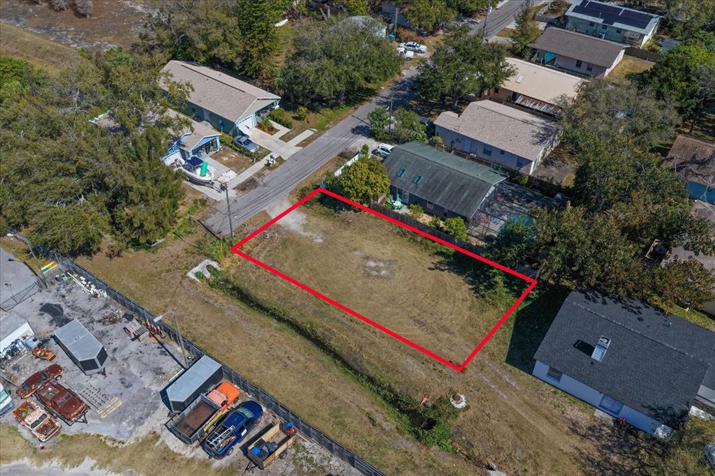 An aerial view shows a vacant rectangular lot outlined in red next to residential houses — BRAGINTON STREET, LARGO, FL