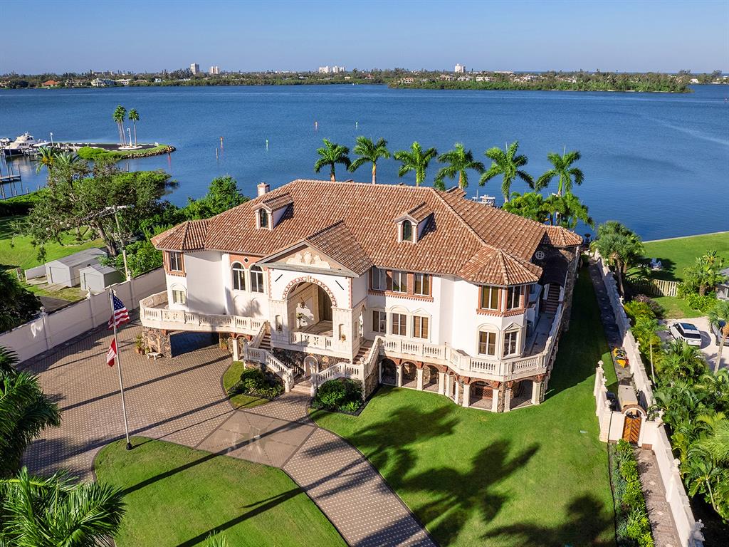 A large, multi-story Mediterranean-style mansion with a paved driveway and waterfront views — 1310 S LAKE SHORE DRIVE, SARASOTA, FL