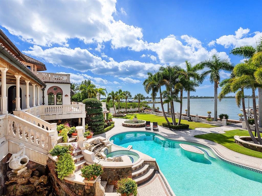 An aerial view of a large waterfront mansion with a tiled roof and paved driveway — 1310 S LAKE SHORE DRIVE, SARASOTA, FL