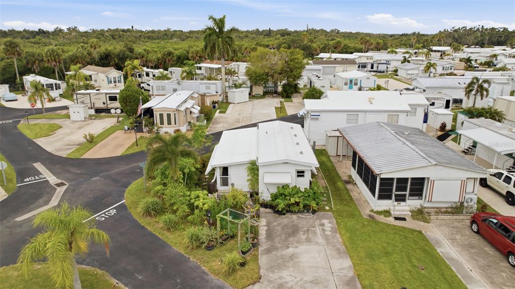 An aerial view shows several mobile homes with driveways and landscaping in a residential community — 2215 73RD STREET E UNIT 162, PALMETTO, FL