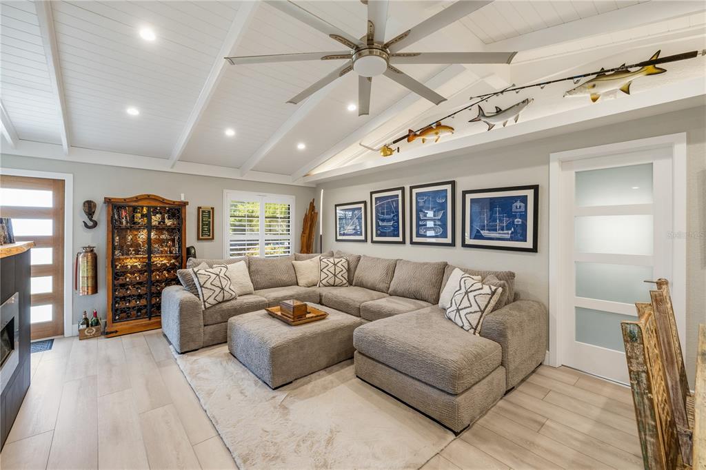 A living room features a sectional sofa, a wine cabinet, and nautical decor on the ceiling — 19154 NEW HAVEN COURT, PORT CHARLOTTE, FL