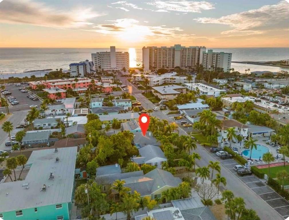 An aerial view shows a residential property marked with a pin near a coastal beach — 564 70TH AVENUE, ST PETE BEACH, FL