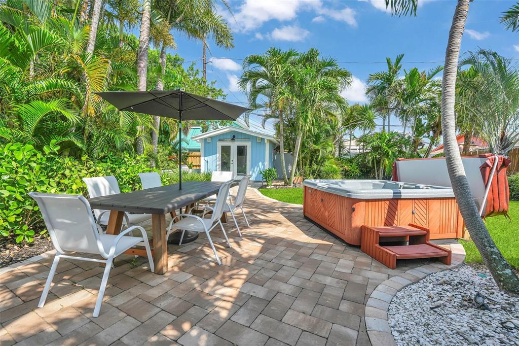 A kitchen features white cabinets, granite countertops, stainless steel appliances, and two windows — 564 70TH AVENUE, ST PETE BEACH, FL