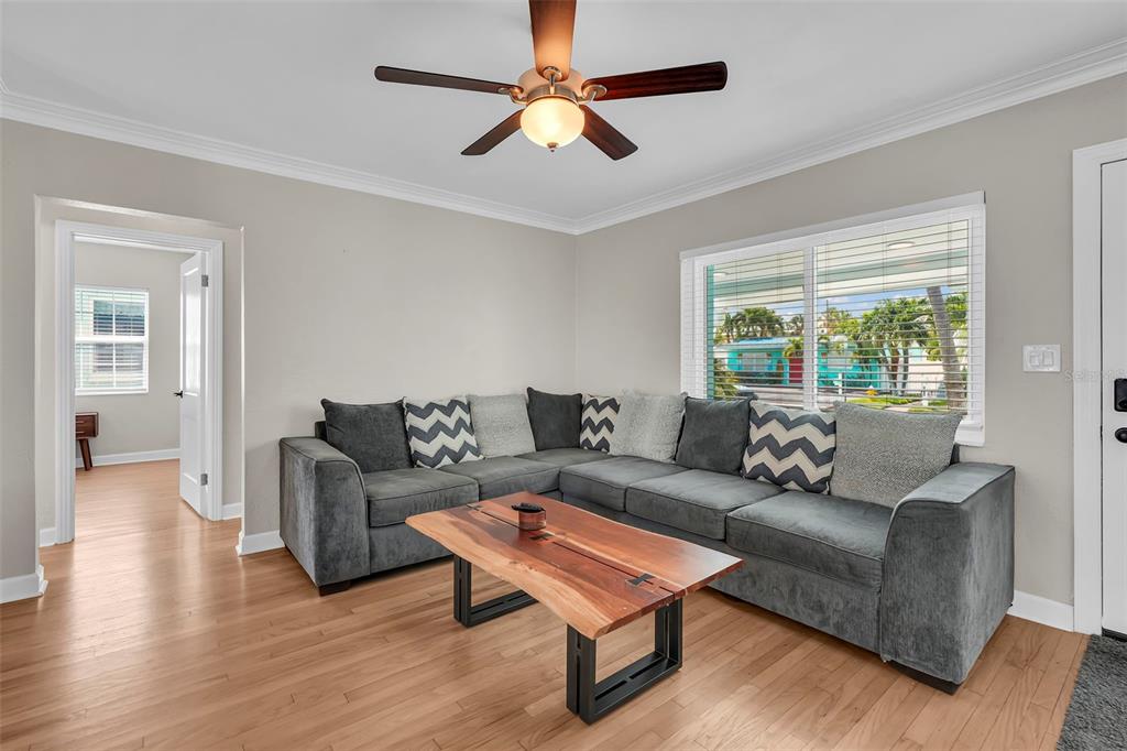 A paved patio features a dining set with an umbrella and a wooden hot tub — 564 70TH AVENUE, ST PETE BEACH, FL