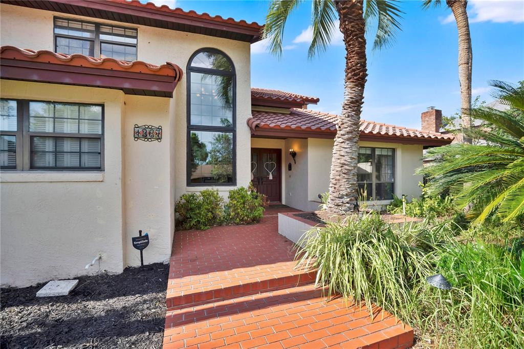 A kitchen with white cabinets, granite countertops, a breakfast bar, and a view of a patio — 1367 CAMPBELL STREET, ORLANDO, FL