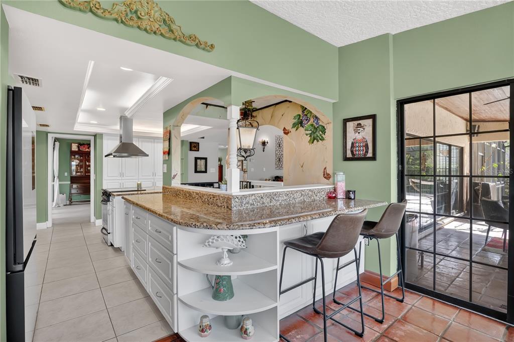 An entryway features a wooden double door, a carpeted staircase, and light-colored tile flooring — 1367 CAMPBELL STREET, ORLANDO, FL