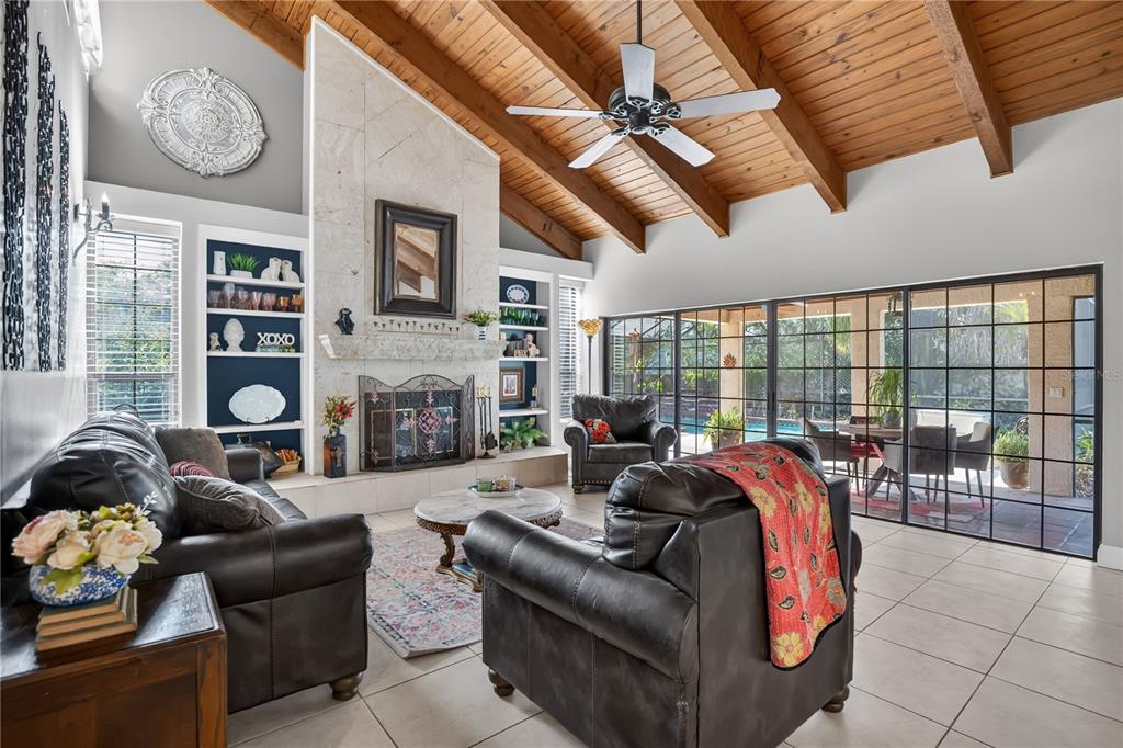 A dining room features a wooden table, chairs, bench, chandelier, and green walls — 1367 CAMPBELL STREET, ORLANDO, FL