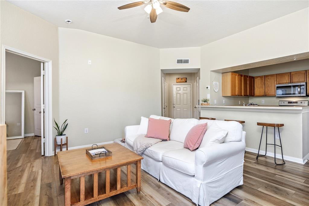 An aerial view shows a community pool area with a waterslide, spa, and surrounding landscaping — 5125 PALM SPRINGS BOULEVARD UNIT 1204, TAMPA, FL