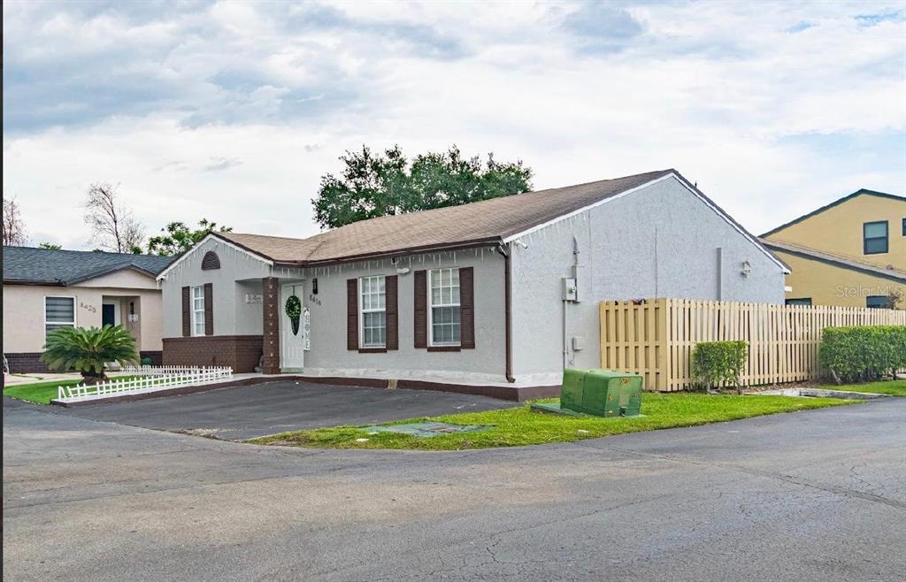 A single-story house with a gray stucco exterior, brown shutters, and a paved driveway — 8419 NW 193RD LN, HIALEAH, FL