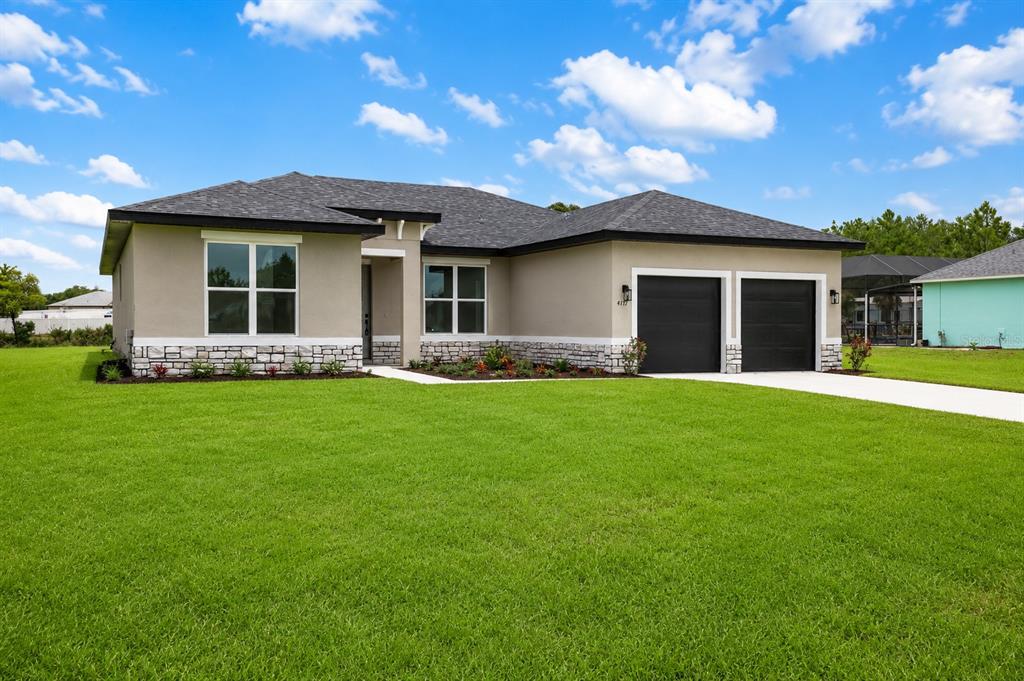 This is a rendering of an open-concept living room and kitchen with gray cabinetry — 4177 SW 100TH STREET, OCALA, FL