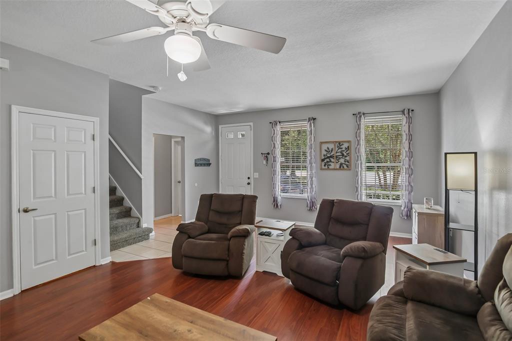 A kitchen with white cabinets, stainless steel appliances, and light-colored tile flooring — 34842 TEEVIEW LANE, ZEPHYRHILLS, FL
