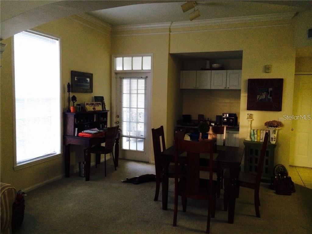 A dining area with a desk, a glass-paned door, and carpeted flooring — 229 LONGVIEW AVENUE UNIT 5303, CELEBRATION, FL