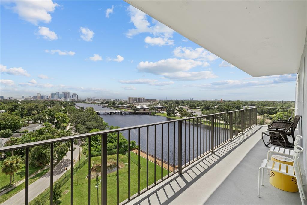 A high-rise balcony overlooks a river, a bridge, and a distant city skyline — 2780 N RIVERSIDE DRIVE UNIT 805, TAMPA, FL