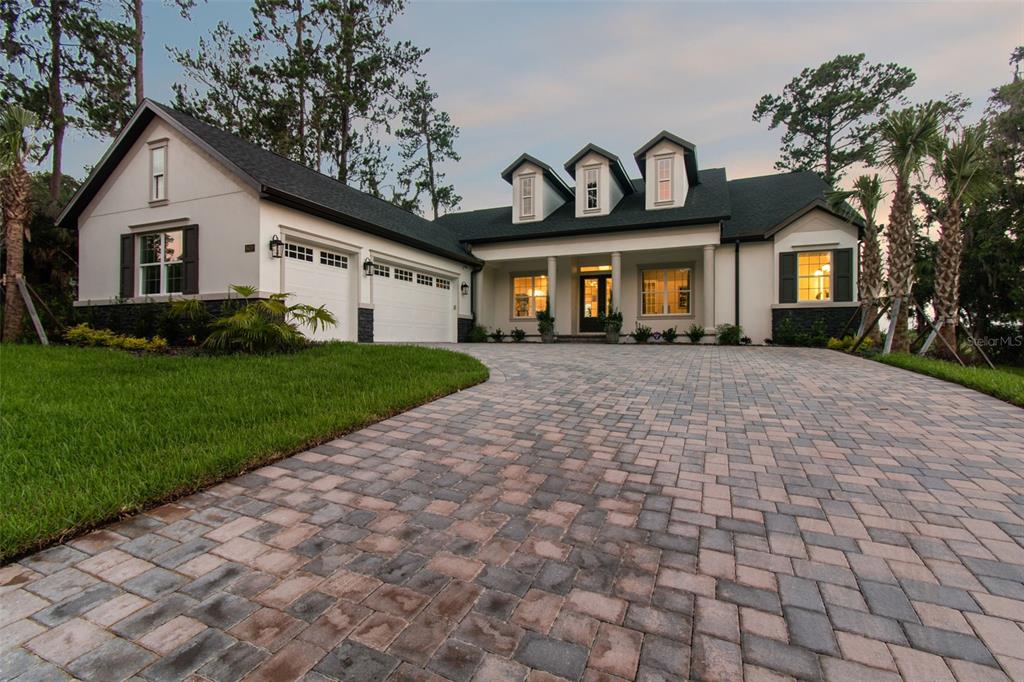 A single-story house with a paved driveway, three dormer windows, and an attached garage — 6470 SUMMIT VIEW DRIVE, BROOKSVILLE, FL