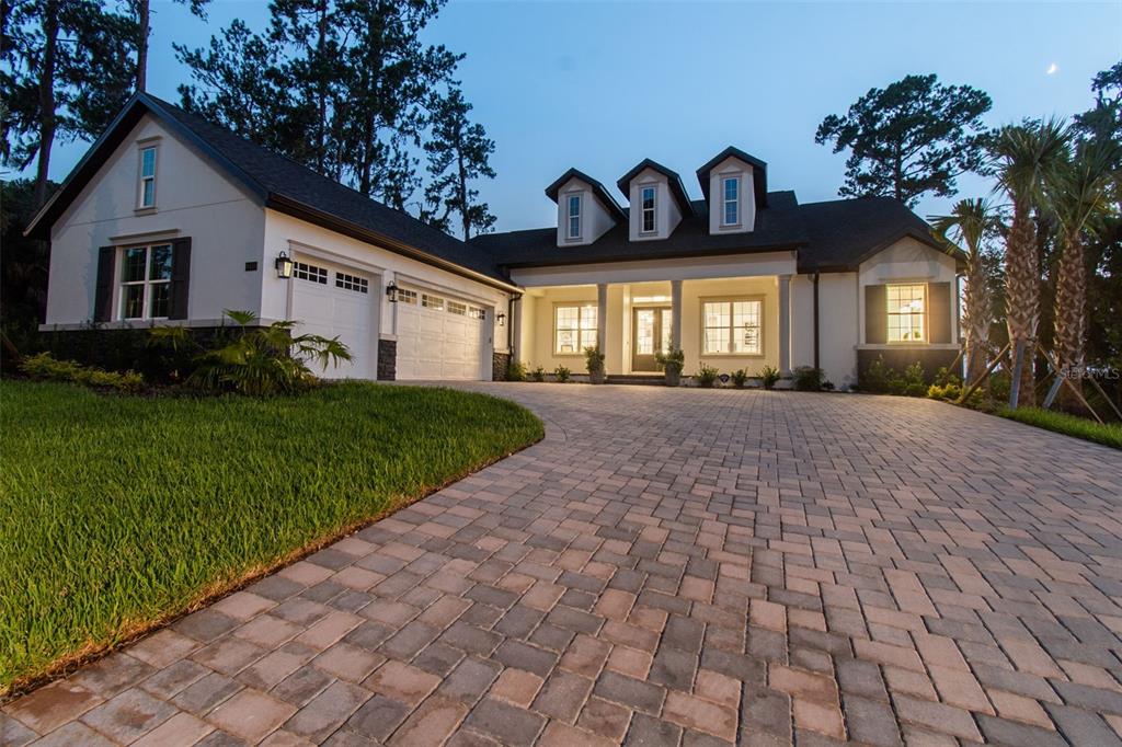A single-story house with a paved driveway, three dormer windows, and an attached garage — 6470 SUMMIT VIEW DRIVE, BROOKSVILLE, FL