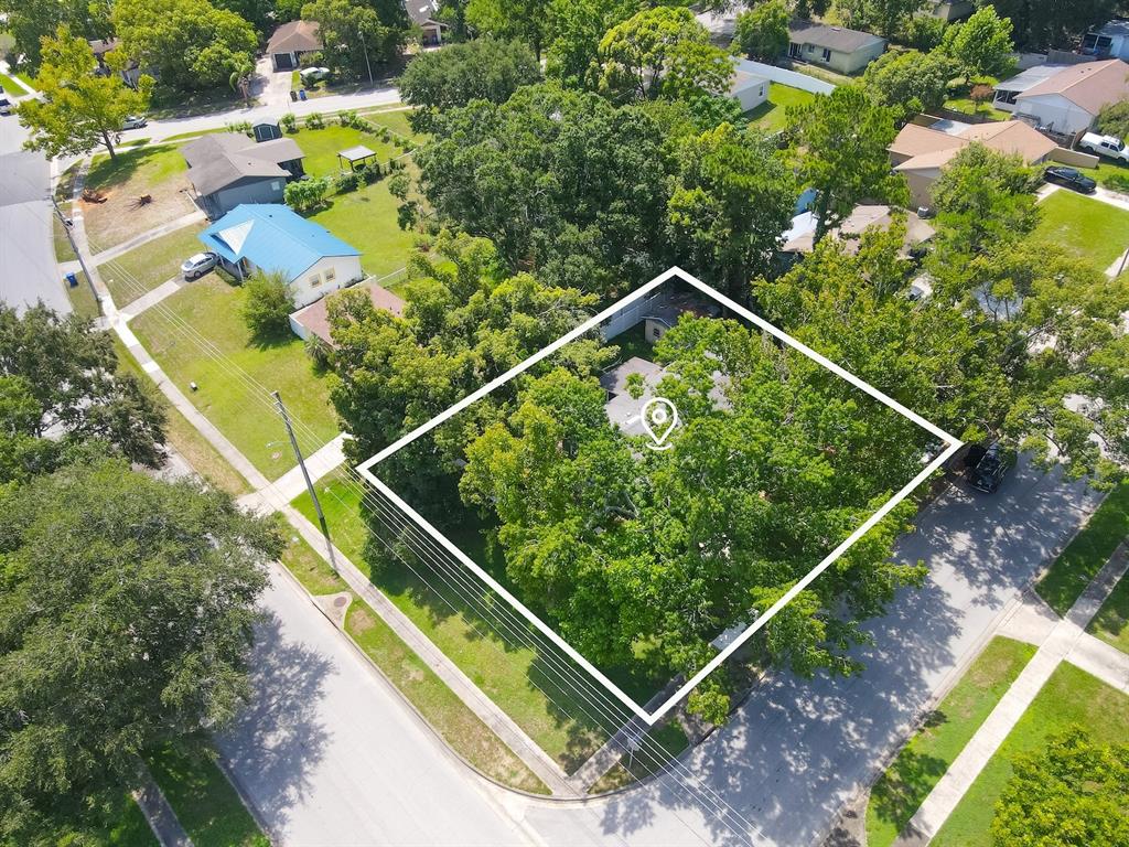 An aerial view shows a residential property lot outlined in white, surrounded by mature trees — 2011 NANCY ANN TERRACE, OCOEE, FL