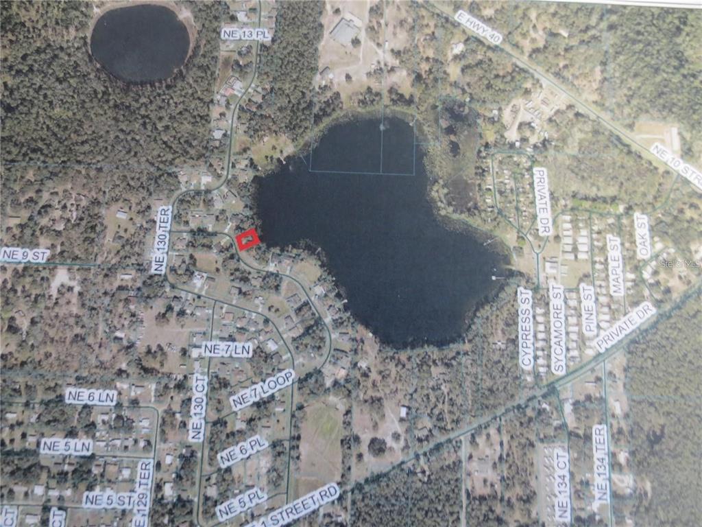 This is an aerial map showing a lake surrounded by residential streets and wooded areas — TBD 7TH LOOP, SILVER SPRINGS, FL