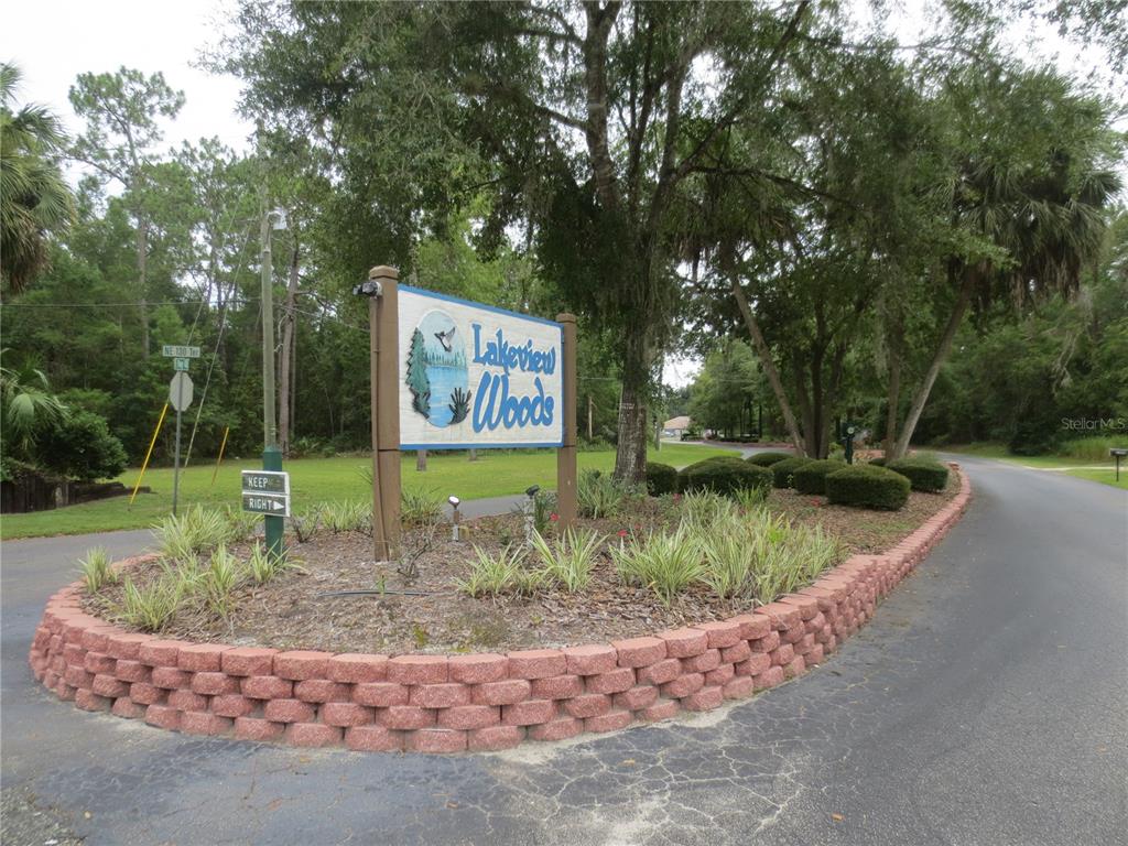 A sign for Lakeview Woods stands in a landscaped island at a road intersection — TBD 7TH LOOP, SILVER SPRINGS, FL