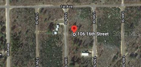 This is a satellite map view showing a vacant lot marked with a red pin — 106 16TH STREET, INTERLACHEN, FL