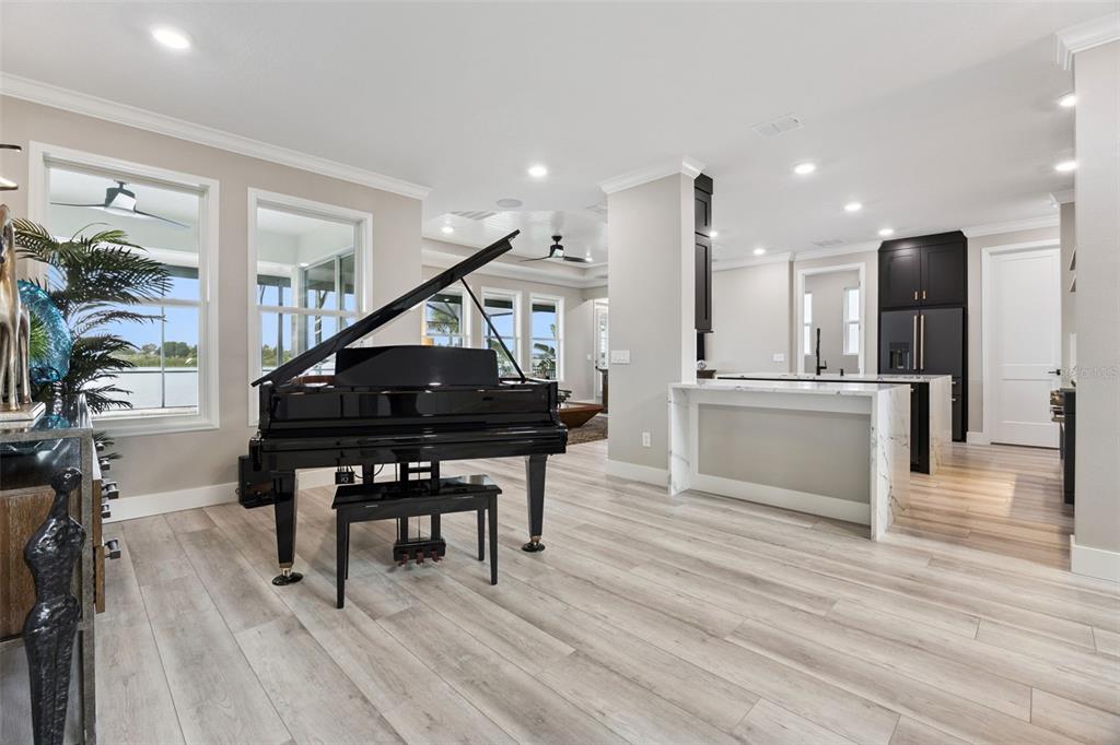 A dining room with a wooden table, upholstered chairs, and a grand piano nearby — 433 BLUE CYPRESS DRIVE, GROVELAND, FL