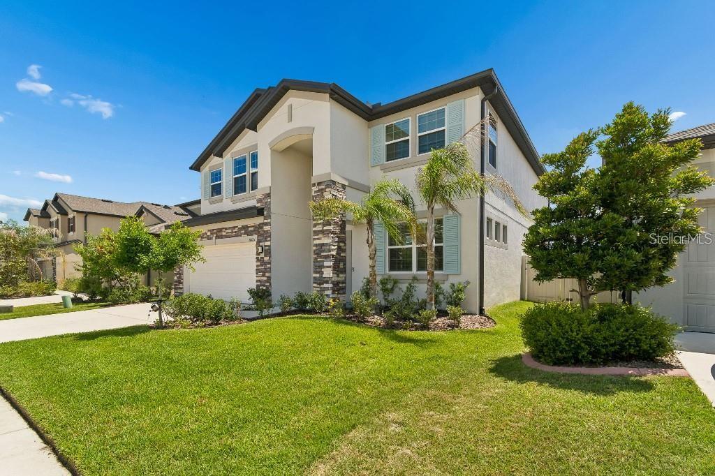 A two-story suburban house with a stone facade, a two-car garage, and a front lawn — 16011 SONOMA GROVE CIRCLE, TAMPA, FL