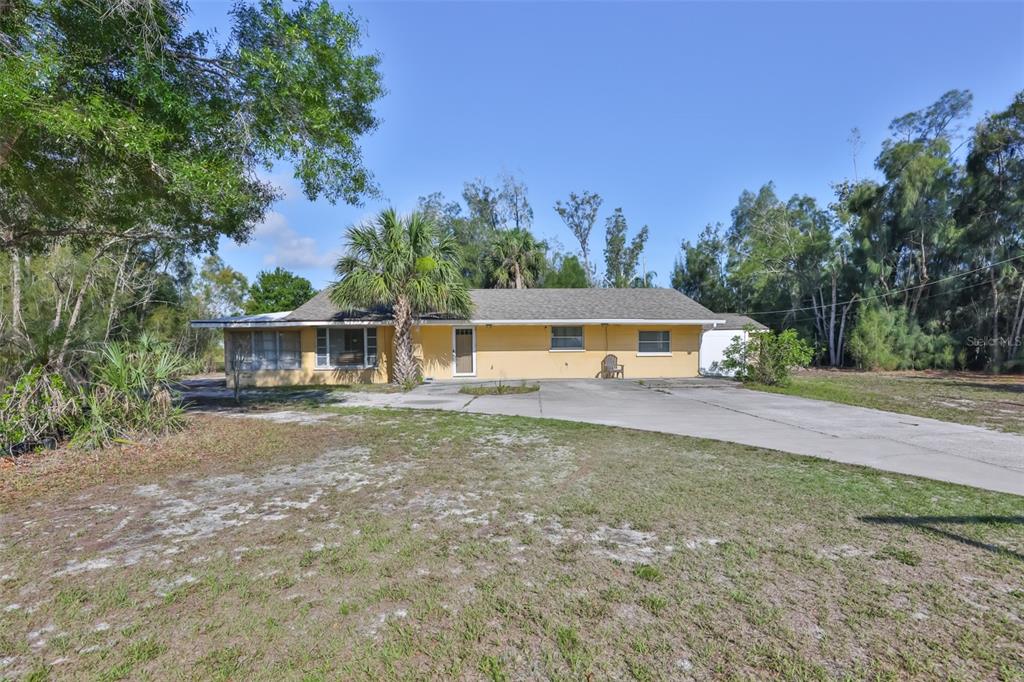 An aerial view shows a rectangular property outlined in red containing trees and structures — 14451 HIGHLAND ROAD, WIMAUMA, FL