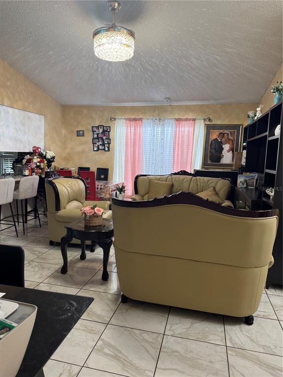 A living room features light-colored tile floors, a beige sofa set, and a ceiling fan — 3407 LAKE TINY CIRCLE, ORLANDO, FL