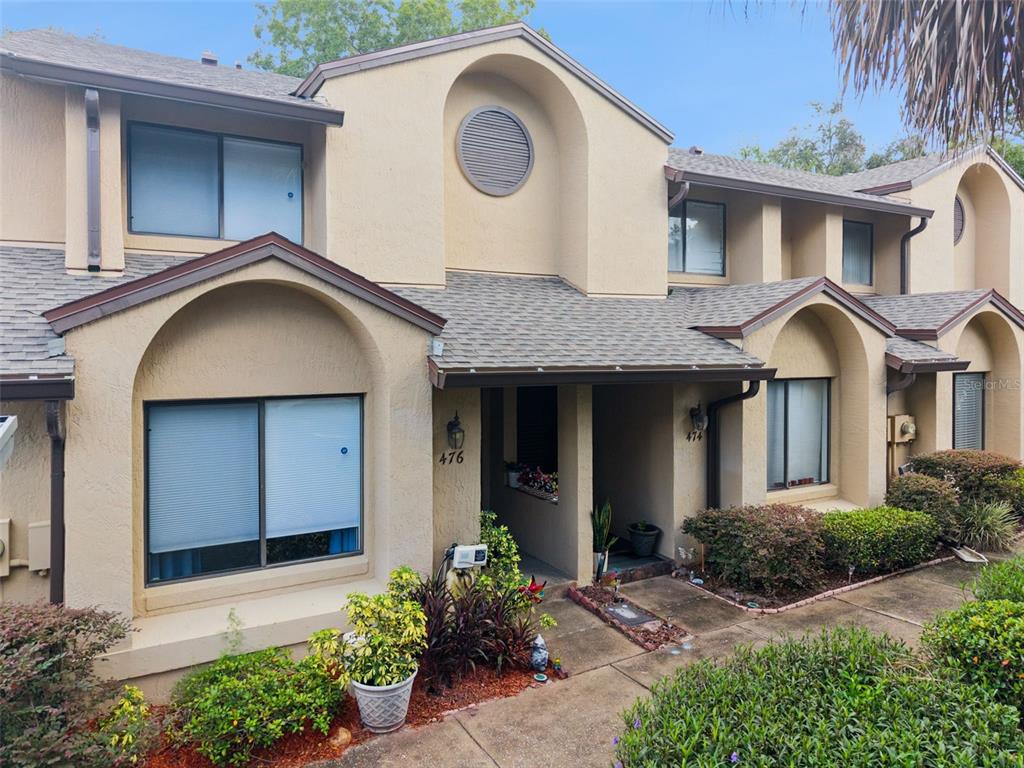 An entryway features a white console table, a radiator cover, and a door with blinds — 476 CLUB DRIVE, WINTER SPRINGS, FL