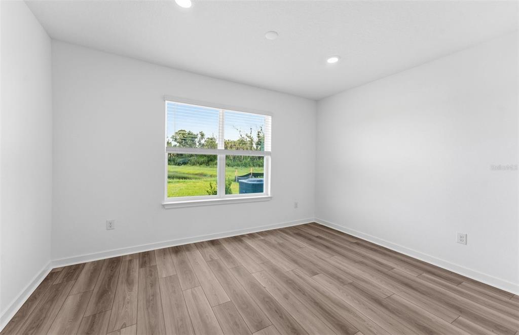 A kitchen with dark cabinets, a white island, stainless steel appliances, and tile flooring — 9885 TRELLIS VINE WAY, PARRISH, FL